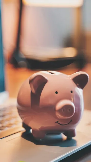 A piggy bank on a laptop