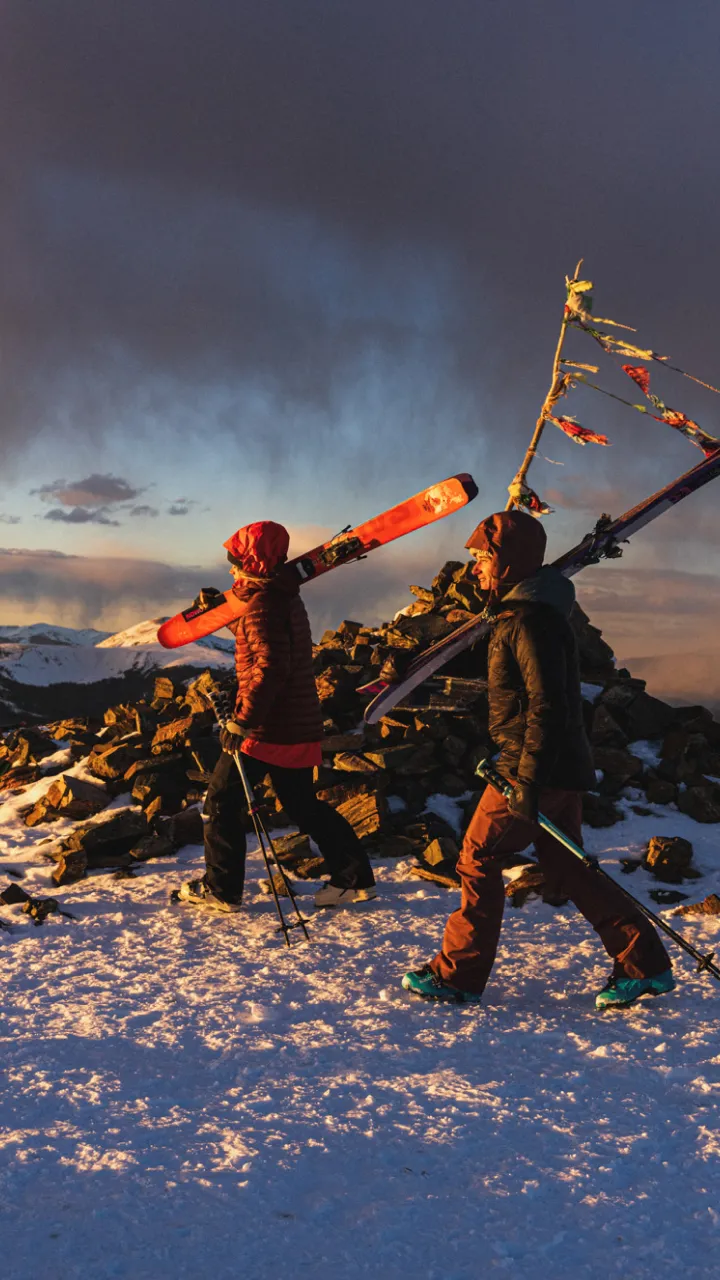 people walking in stormy sunset on Kachina Peak