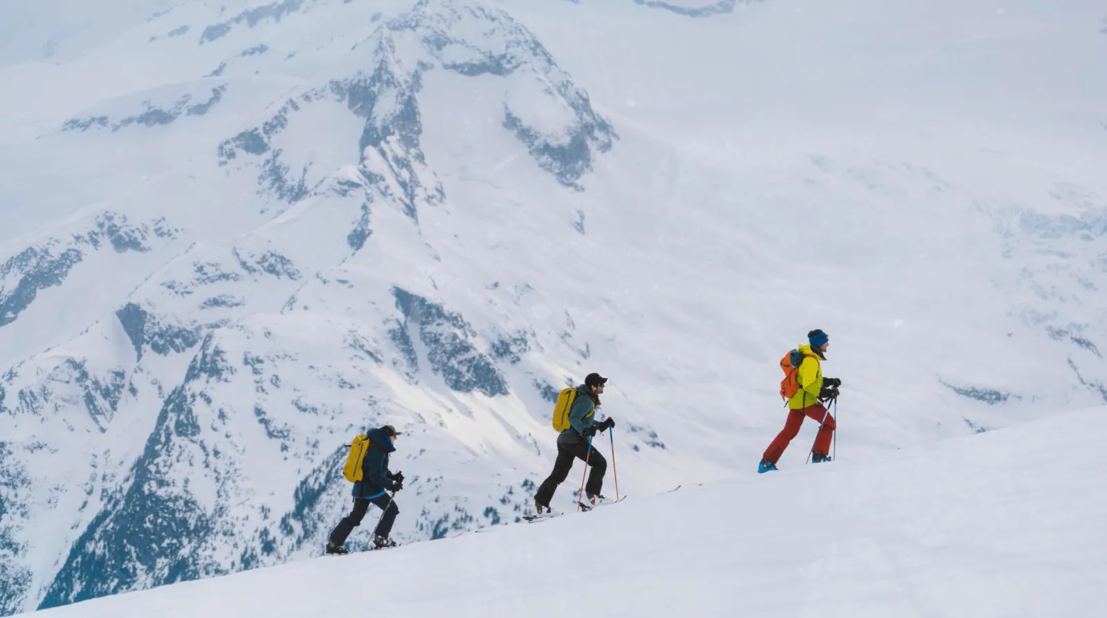 3-people skinning up a mountain