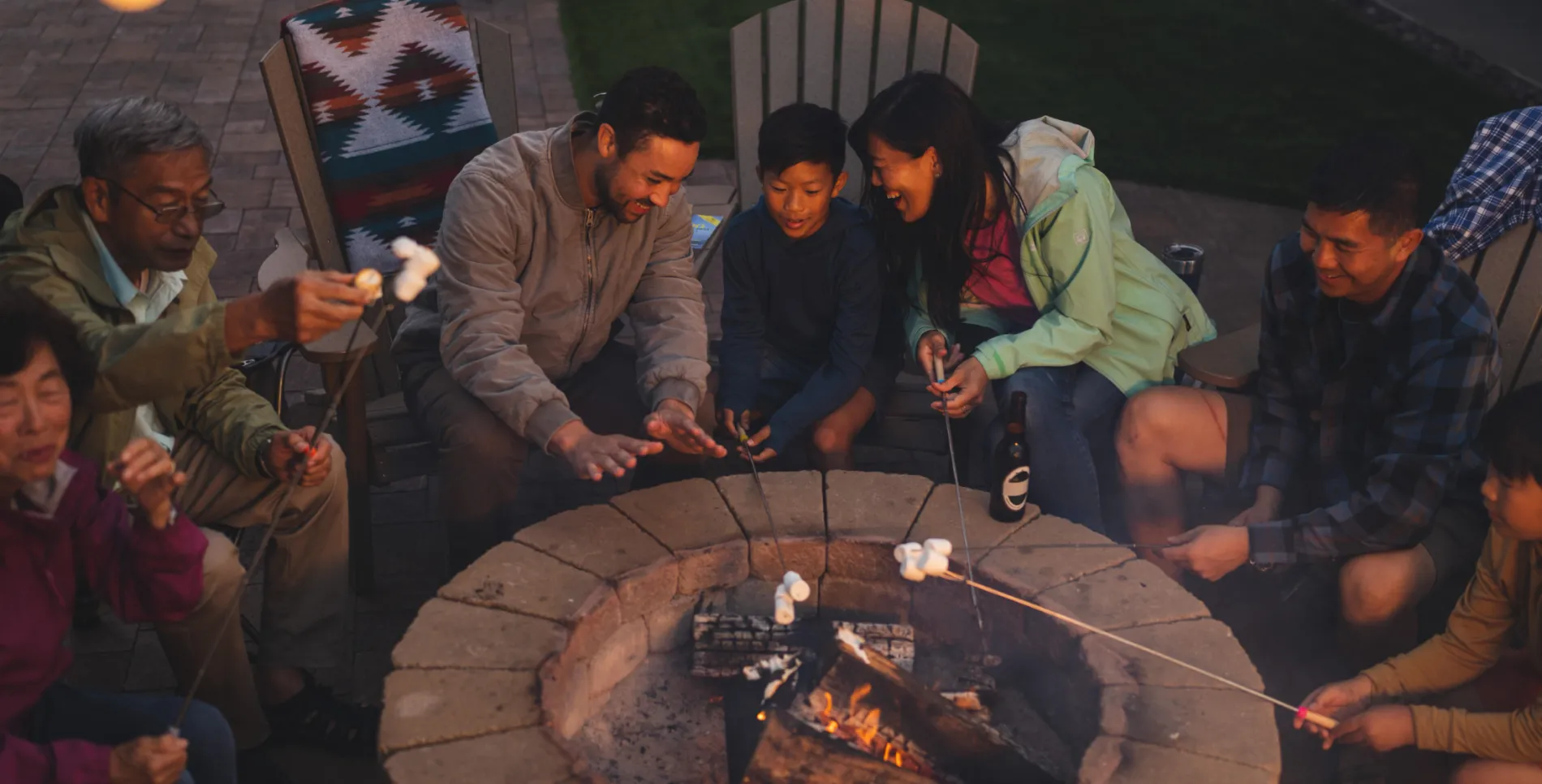 A family roasting marshmallows around a fire