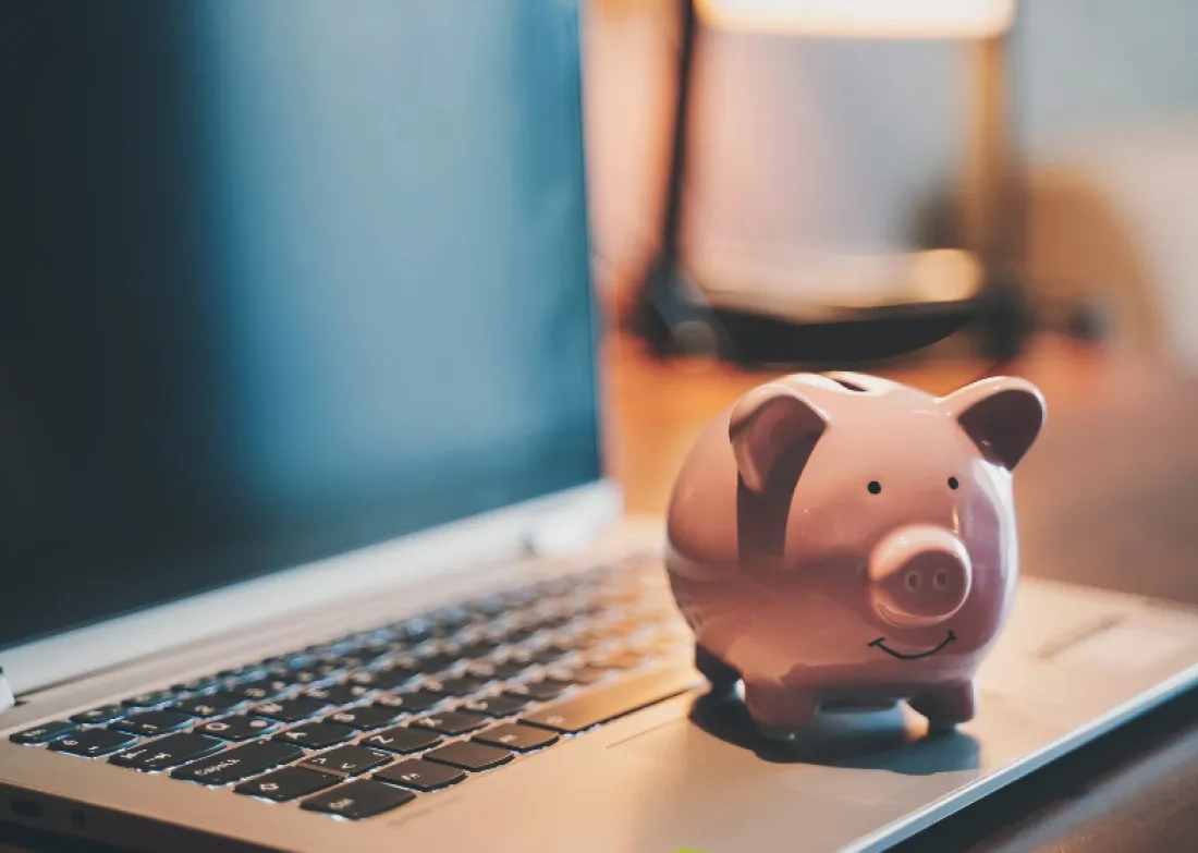 A piggy bank on a laptop