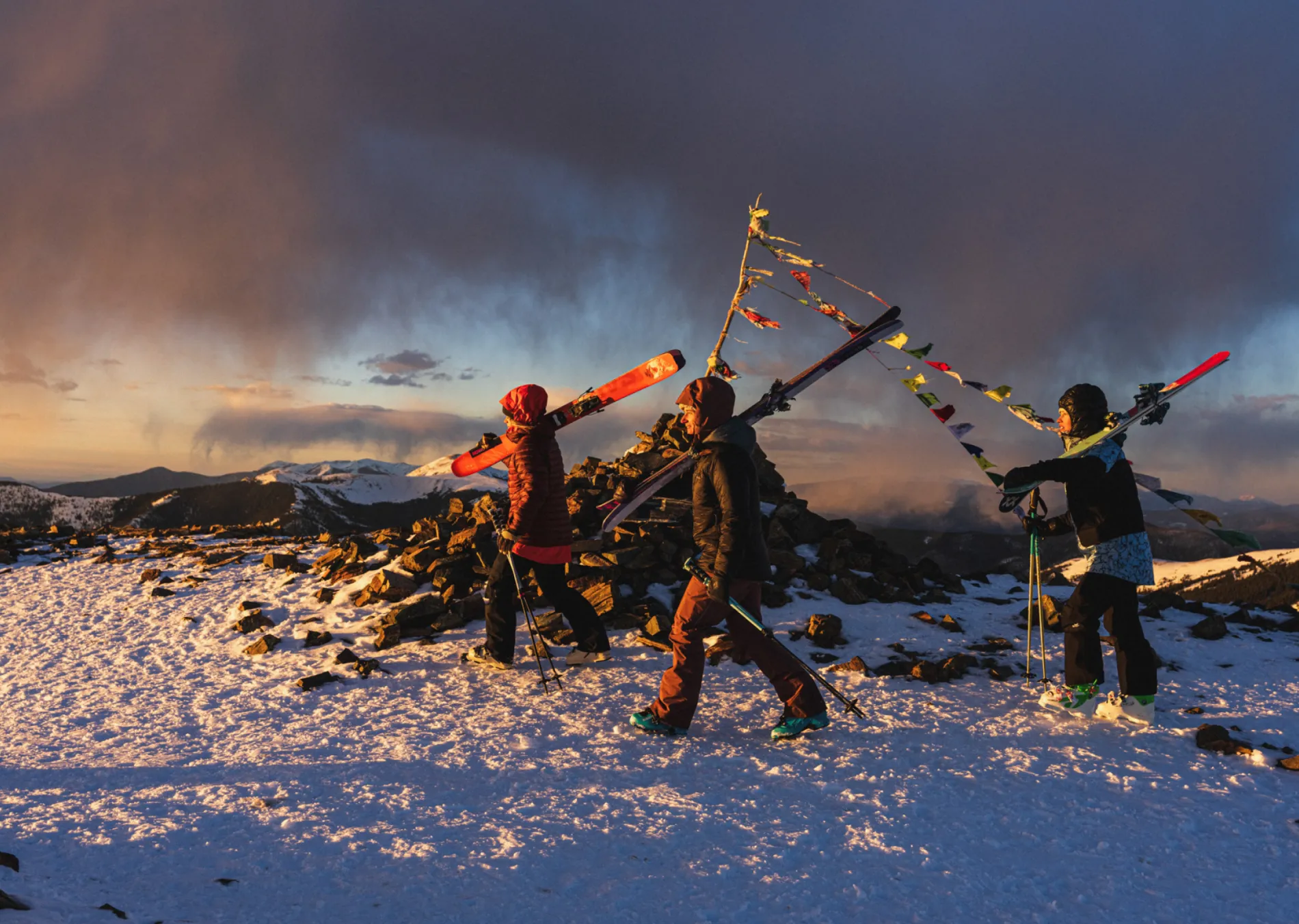 people walking in stormy sunset on Kachina Peak